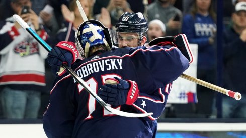 Nick Foligno and Sergei Bobrovsky hug after a win. 