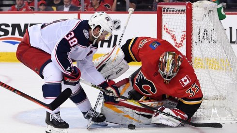 David Rittich makes a save against Columbus Blue Jackets forward Boone Jenner