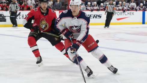 Alexandre Texier skates with the puck in front of Chris Tierney at the Canadian Tire Centre