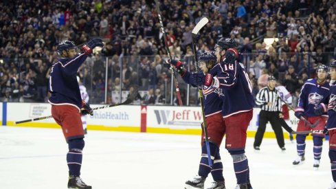 Seth Jones, Artemi Panarin and Pierre-Luc Dubois celebrate a goal scored against the New York Rangers at Nationwide Arena.