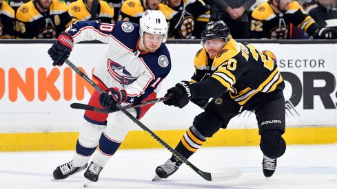 Alexander Wennberg fights for a loose puck against the Boston Bruins