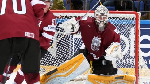 Elvis Merzlikins makes a save for Latvia at the World Championships in Slovakia