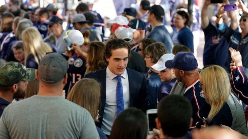 Columbus Blue Jackets left wing Sonny Milano (22) high fives fans while walking the Blue Carpet entrance prior to the game against the Carolina Hurricanes at Nationwide Arena.