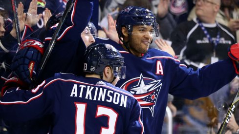 Columbus Blue Jackets forward Cam Atkinson celebrates alongside defensemen Zach Werenski and Seth Jones during a regular-season matchup with the Pittsburgh Penguins in April of 2018. 