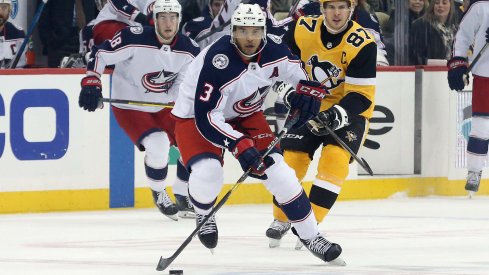 Columbus Blue Jackets defenseman Seth Jones (3) skates up ice with the puck ahead of Pittsburgh Penguins center Sidney Crosby (87) during the first period at PPG PAINTS Arena.