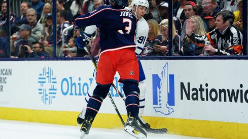 Columbus Blue Jackets defenseman skates toward John Tavares of the Toronto Maple Leafs during his team's home opener at Nationwide Arena.