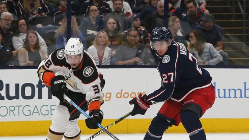 Columbus Blue Jackets defenseman battles for the puck in a regular-season matchup with the Anaheim Ducks at Nationwide Arena during October of 2019.