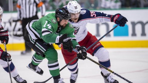 Dallas Stars left wing Jamie Benn (14) and Columbus Blue Jackets defenseman David Savard (58) chase the puck during the third period at the American Airlines Center.