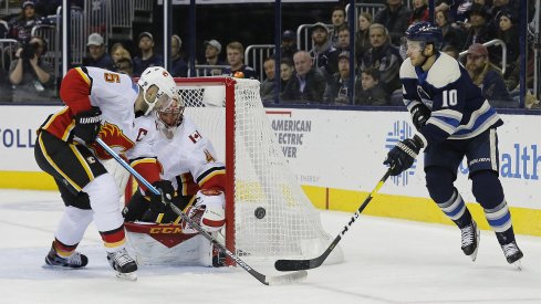 Calgary Flames defenseman Mark Giordano (5) knocks down the shot of Columbus Blue Jackets center Alexander Wennberg (10) during the second period at Nationwide Arena.