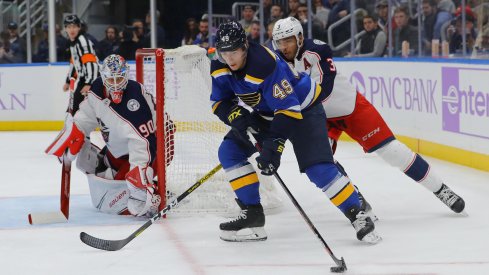 Nov 1, 2019; St. Louis, MO, USA; St. Louis Blues center Ivan Barbashev (49) skates with the puck as Columbus Blue Jackets defenseman Seth Jones (3) and goaltender Elvis Merzlikins (90) defend the net during the second period at Enterprise Center.