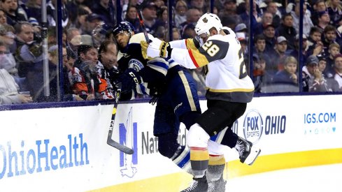 Columbus Blue Jackets defenseman Seth Jones (3) is checked along the boards by Vegas Golden Knights left wing William Carrier (28) in the third period at Nationwide Arena.