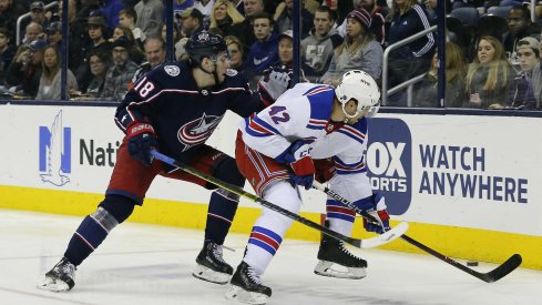 Jan 13, 2019; Columbus, OH, USA; Columbus Blue Jackets left wing Pierre-Luc Dubois (18) and New York Rangers defenseman Brendan Smith (42) battle the puck during the second period at Nationwide Arena. Mandatory Credit: Russell LaBounty-USA TODAY Sports