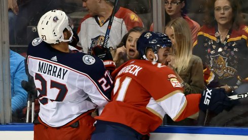 Oct 11, 2018; Sunrise, FL, USA; Columbus Blue Jackets defenseman Ryan Murray (27) is checked into the boards by Florida Panthers center Vincent Trocheck (21) during the third period at BB&T Center.