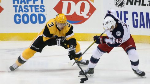 Pittsburgh Penguins defenseman Jack Johnson (3) and Columbus Blue Jackets center Alexandre Texier (42) battle for the puck during the second period at PPG PAINTS Arena. Mandatory Credit: Charles LeClaire-USA TODAY Sports