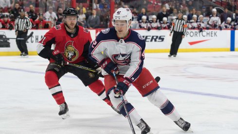 Apr 6, 2019; Ottawa, Ontario, CAN; Columbus Blue Jackets center Alexandre Texier (42) skates wit hthe puck in front of Ottawa Senators center Chris Tierney (71) in the first period at the Canadian Tire Centre.