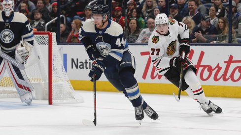 Dec 29, 2019; Columbus, Ohio, USA; Columbus Blue Jackets defenseman Vladislav Gavrikov (44) carries the puck away from Chicago Blackhawks center Kirby Dach (77) during the second period at Nationwide Arena.