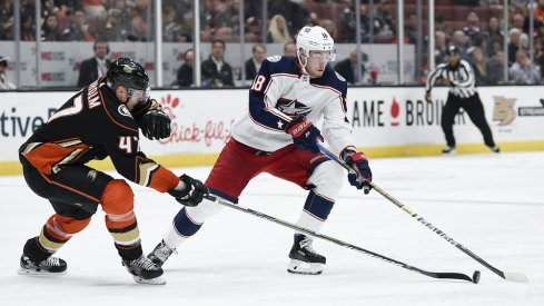 Columbus Blue Jackets center Pierre-Luc Dubois (18) handles the puck while under pressure by Anaheim Ducks defenseman Hampus Lindholm (47) during the second period at Honda Center.