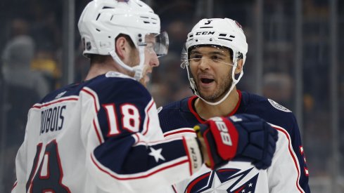 Pierre-Luc Dubois and Seth Jones celebrate an overtime-winning goal against the Boston Bruins.