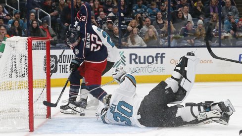  Columbus Blue Jackets left wing Sonny Milano (22) reaches for the rebound against San Jose Sharks goalie Aaron Dell (30) during the second period at Nationwide Arena.