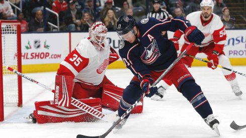 Nov 21, 2019; Columbus, OH, USA; Columbus Blue Jackets right wing Cam Atkinson (13) backhands the puck on net against the Detroit Red Wings during the second period at Nationwide Arena.