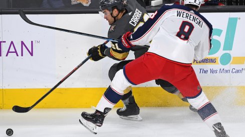 Columbus Blue Jackets defenseman Zach Werenski (8) checks Vegas Golden Knights left wing William Carrier (28) during the first period at T-Mobile Arena