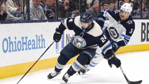 Jan 22, 2020; Columbus, Ohio, USA; Columbus Blue Jackets center Nathan Gerbe (24) carries the puck away from Winnipeg Jets defenseman Luca Sbisa (5) during the second period at Nationwide Arena.