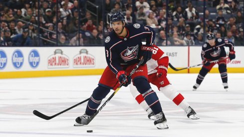 Blue Jackets defenseman Seth Jones controls the puck in the neutral zone.