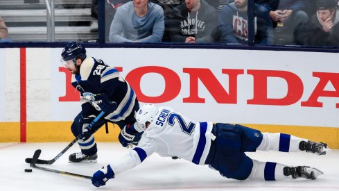 Feb 10, 2020; Columbus, Ohio, USA; Columbus Blue Jackets right wing Oliver Bjorkstrand (28) controls the puck as Tampa Bay Lightning defenseman Luke Schenn (2) loses his footing in the second period at Nationwide Arena.