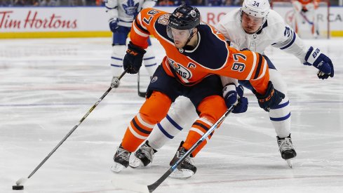 The Edmonton Oilers Connor McDavid and the Toronto Maple Leafs Auston Matthews fight for position