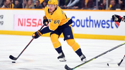 Feb 25, 2020; Nashville, Tennessee, USA; Nashville Predators center Mikael Granlund (64) skates with the puck during the first period against the Ottawa Senators at Bridgestone Arena.