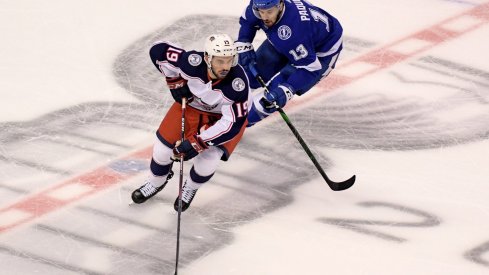 Aug 13, 2020; Toronto, Ontario, CAN; Columbus Blue Jackets center Liam Foudy (19) skates with the puck away from Tampa Bay Lightning center Cedric Paquette (13) during the first period in game two of the first round of the 2020 Stanley Cup Playoffs at Scotiabank Arena.