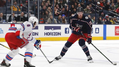 Columbus Blue Jackets center Pierre-Luc Dubois (18) celebrates with right wing Cam Atkinson (13) after scoring an empty net goal in the third period against the Colorado Avalanche at the Pepsi Center. 