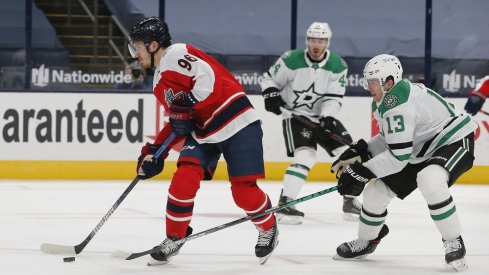 Columbus Blue Jackets center Jack Roslovic (96) looks to pass as Dallas Stars defenseman Mark Pysyk (13) defends during the first period at Nationwide Arena