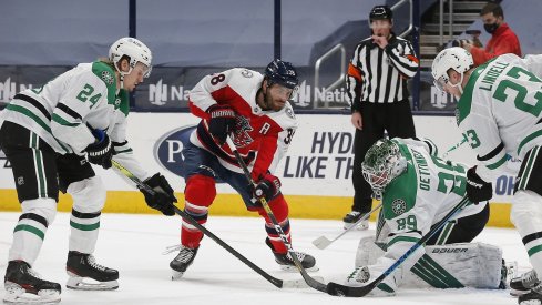 Dallas Stars goalie Jake Oettinger makes a save as Columbus Blue Jackets center Boone Jenner looks for a rebound Tuesday at Nationwide Arena. 