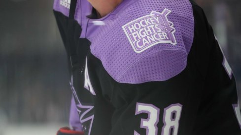 Nov 15, 2019; Columbus, OH, USA; A view of the Hockey Fights Cancer logo on the jersey of Columbus Blue Jackets center Boone Jenner (38) as he skates during warmups prior to the game against the St. Louis Blues at Nationwide Arena.