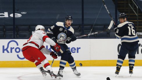  Columbus Blue Jackets defenseman Dean Kukan (46) passes the puck as Carolina Hurricanes defenseman Joakim Ryan (33) defends during the first period at Nationwide Arena.