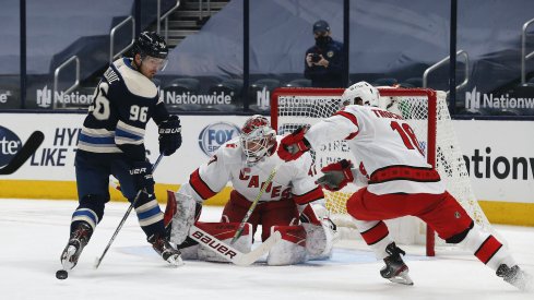 Columbus Blue Jackets center Jack Roslovic (96) reaches back for the loose puck from a Carolina Hurricanes goalie James Reimer (47) save during the third period at Nationwide Arena. 