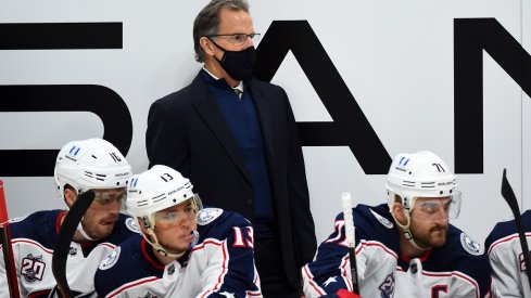 John Tortorella looks on from behind the bench