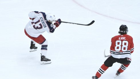 Columbus Blue Jackets right wing Cam Atkinson (13) scores a goal as Chicago Blackhawks right wing Patrick Kane (88) stands nearby during the first period at United Center. 