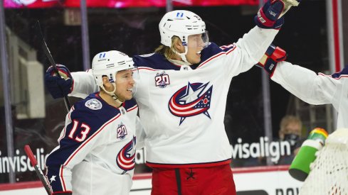 Columbus Blue Jackets right wing Cam Atkinson (13) is congratulated by right wing Patrik Laine (29) after his goal against the Carolina Hurricanes the first period at PNC Arena.