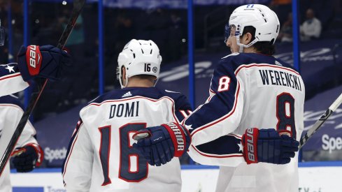 Columbus Blue Jackets defenseman Zach Werenski (8) is congratulated as he scores a goal against the Tampa Bay Lightning during the second period at Amalie Arena.