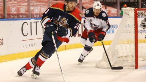 Florida Panthers center Alex Wennberg (21) skates with the puck around Columbus Blue Jackets center Riley Nash (20) during the first period at BB&T Center.