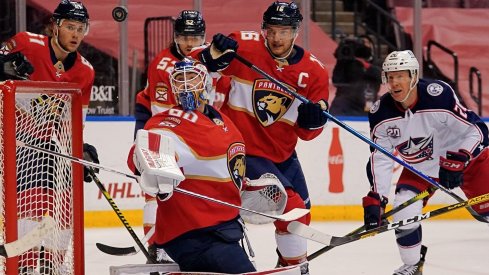 lorida Panthers goaltender Chris Driedger (60) deflects the puck on a shot from Columbus Blue Jackets center Riley Nash (20) during the first period at BB&T Center.