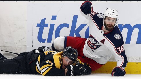 Columbus Blue Jackets forward Boone Jenner competes for the puck against Brady Skjei of the Carolina Hurricanes at Nationwide Arena.