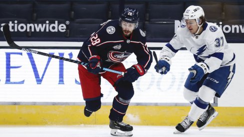 Columbus Blue Jackets forward Oliver Bjorkstrand fights for the puck against Alexander Ovechkin of the Washington Capitals.