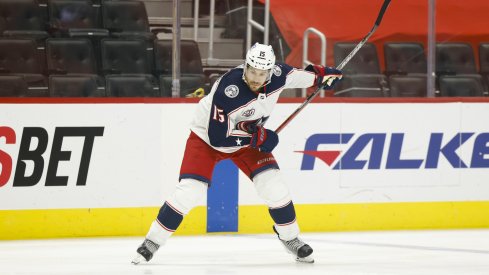 Columbus Blue Jackets defenseman Michael Del Zotto (15) takes a shot in the first period against the Detroit Red Wings at Little Caesars Arena