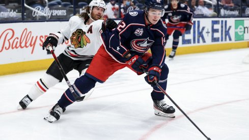 Alexandre Texier controls the puck against Duncan Keith