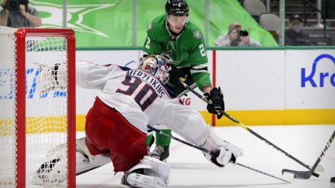 Columbus Blue Jackets goaltender Elvis Merzlikins (90) stops a shot by Dallas Stars defenseman Jamie Oleksiak (2) during the second period at the American Airlines Center.