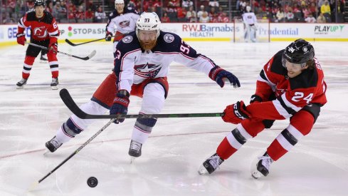 Jakub Voracek fights for a loose puck against the New Jersey Devils