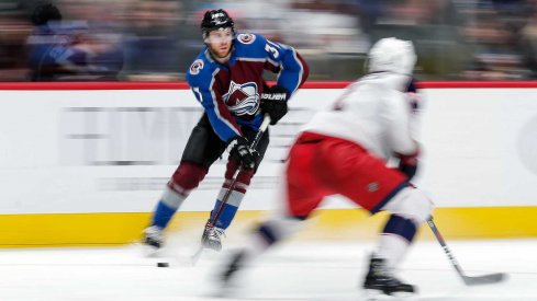 Columbus Blue Jackets defenseman Scott Harrington (4) defends against Colorado Avalanche left wing J.T. Compher (37) in the second period at the Pepsi Center. 